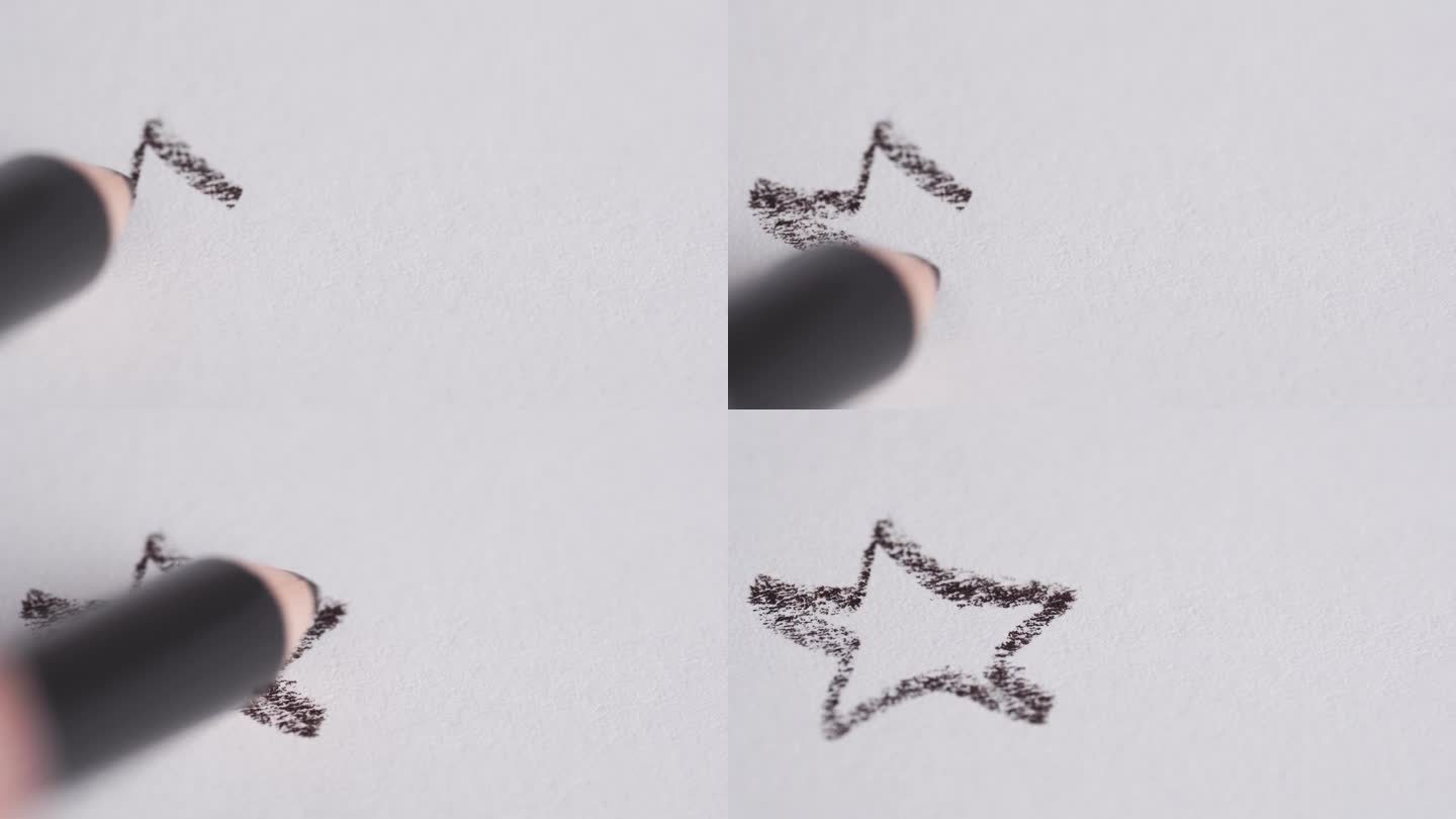 手在白纸上画了一颗星星。一支铅笔画了一颗星星