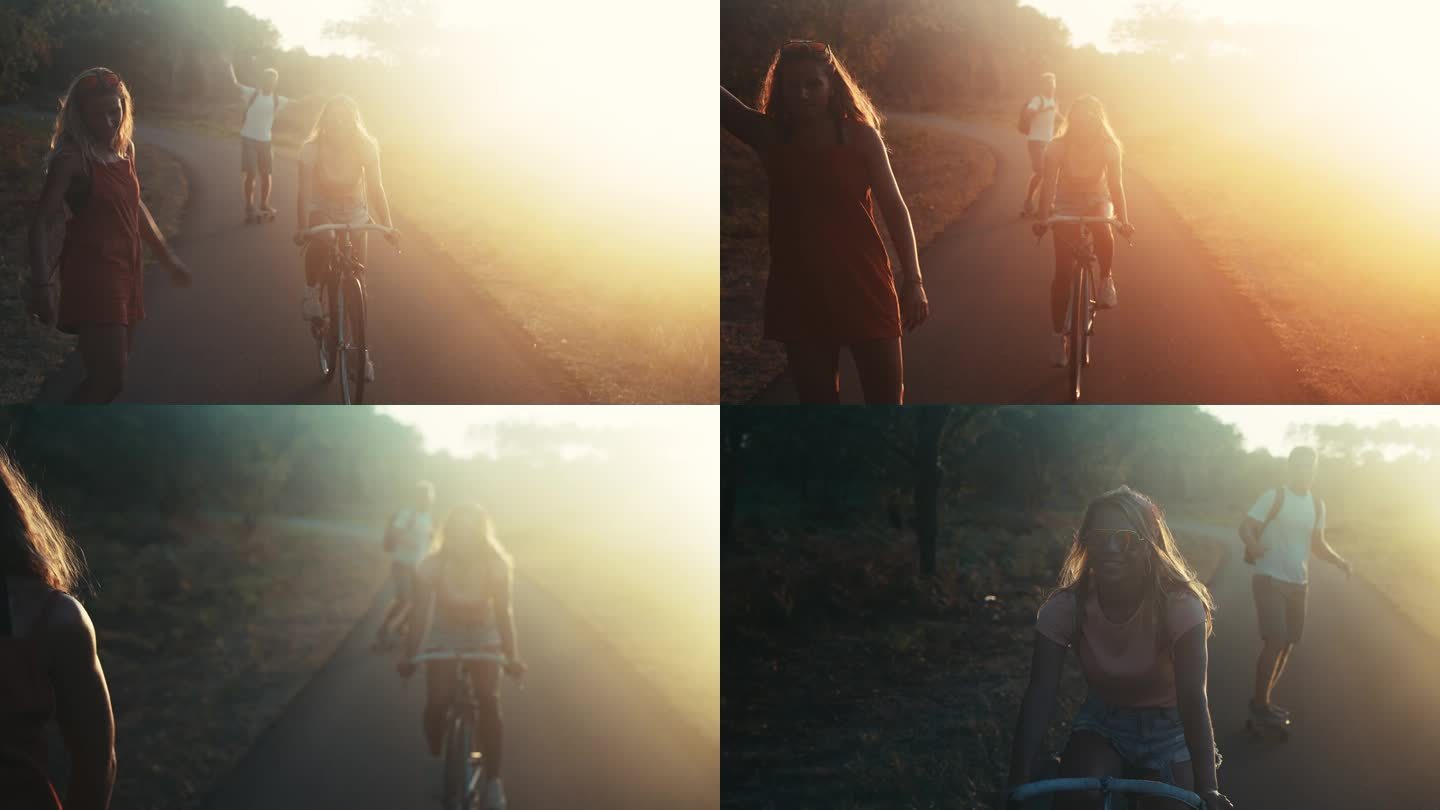 三个朋友骑着自行车和滑板在乡间小路上的剪影