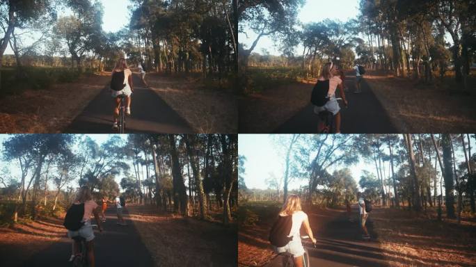 三个朋友在森林路上骑自行车和滑板