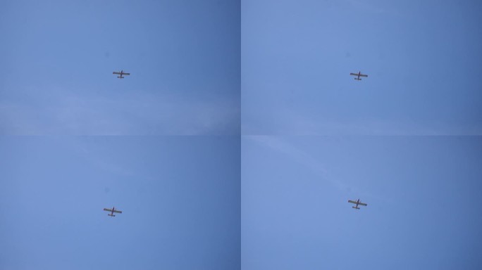 从地面上看，在夏日晴朗的日子里，有两个螺旋桨的民用飞机在蓝天上翱翔。航空、运输、空中飞机的概念。