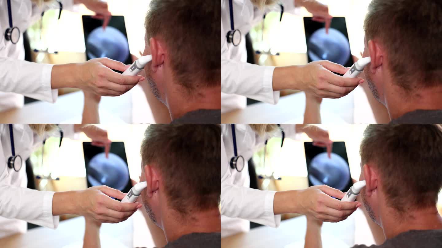 耳鼻喉科医生使用数字耳镜检查患者