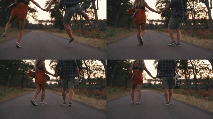 一对情侣扛着滑板在乡间小路上蹦蹦跳跳