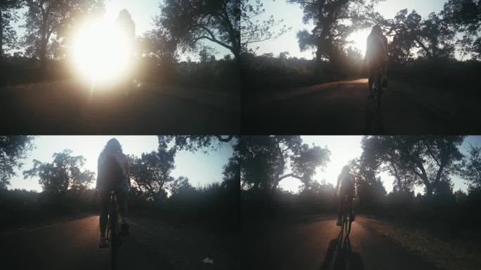 乡村公路上骑自行车的女人的剪影