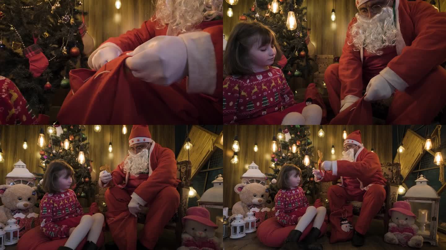 圣诞老人坐在沙发上给一个小女孩她的新年礼物