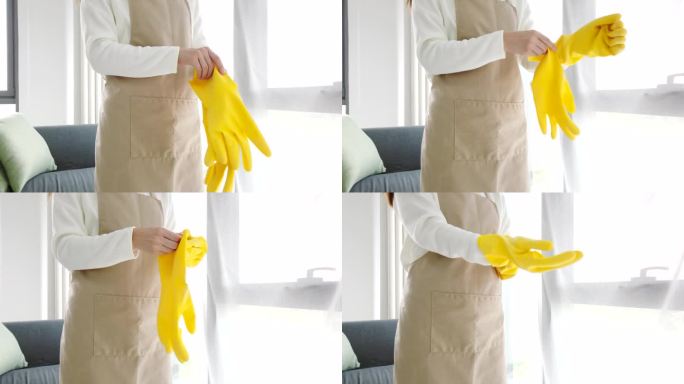 人、家务和持家观念——女人在家里戴上橡胶手套做家务。使用家用化学品时的皮肤安全