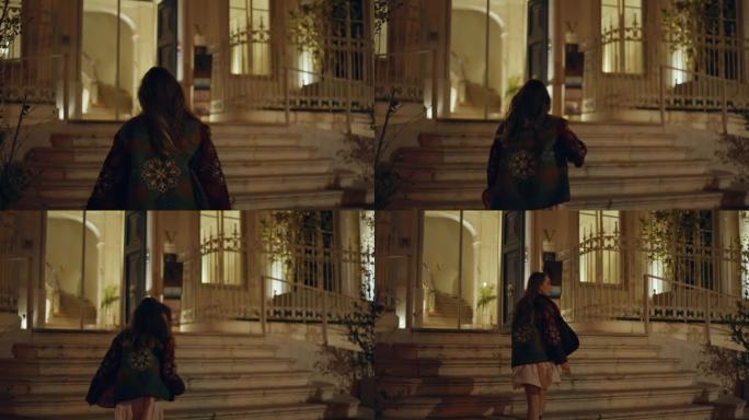 女人上楼，夜楼后景。探索城市建筑的女孩