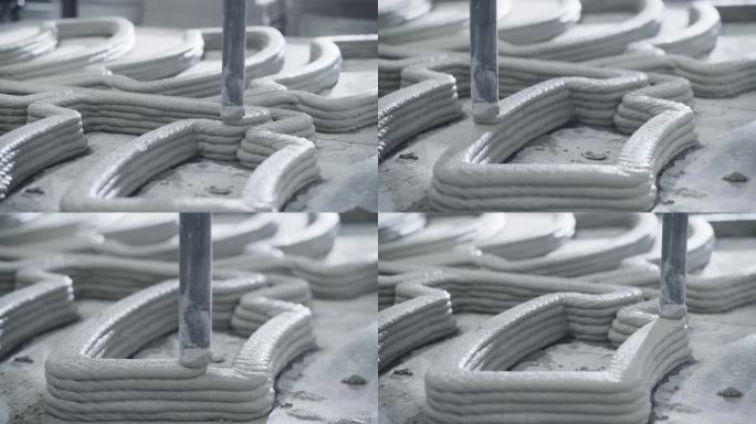 工业建筑3D打印机在高科技生产仓库中的工作特写。创新的房地产公司用水泥打印积木来建造房子。先进自动化