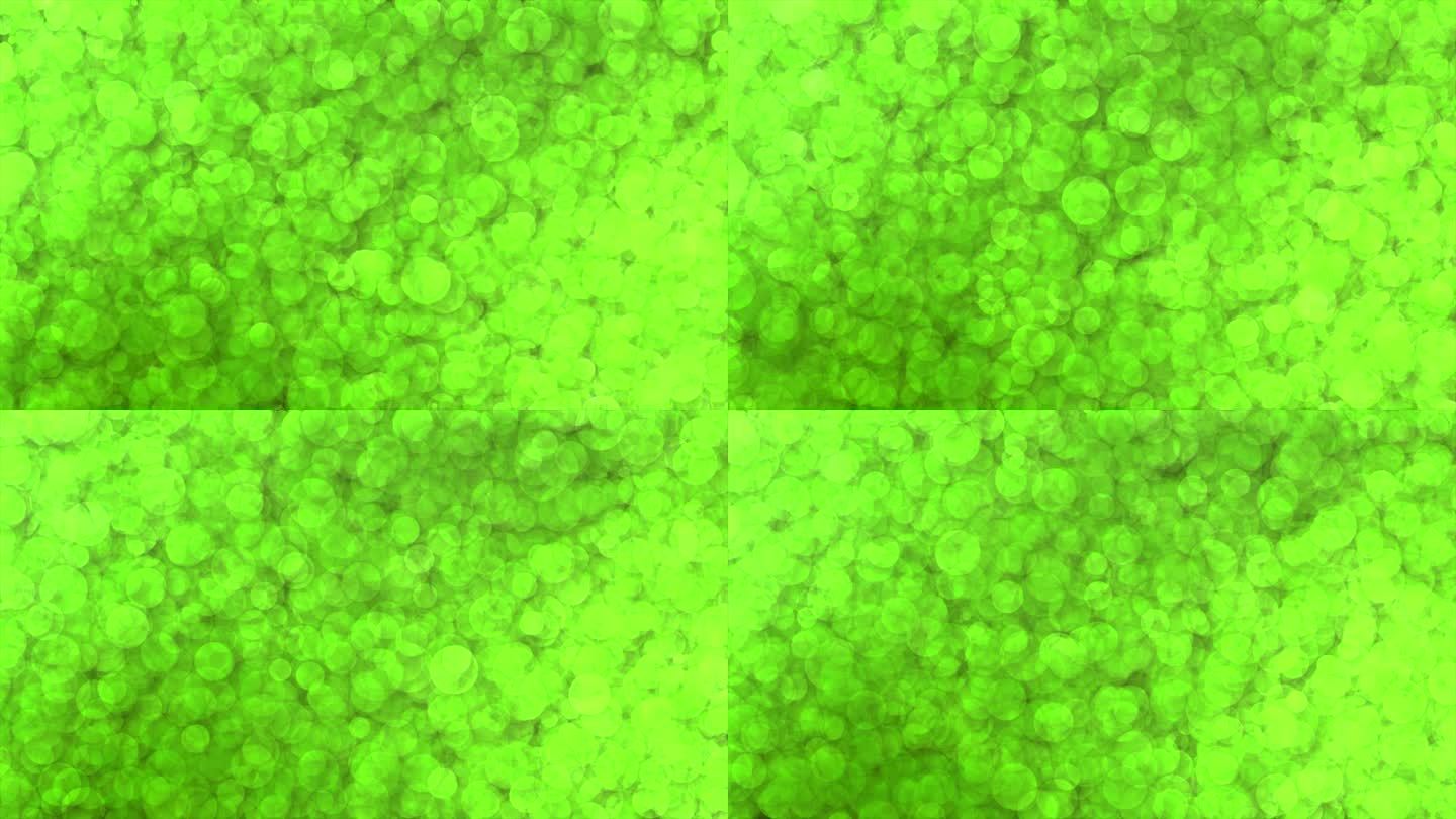 石灰绿色光泽的粒子美丽的背景，出现和消失的移动粒子的背景