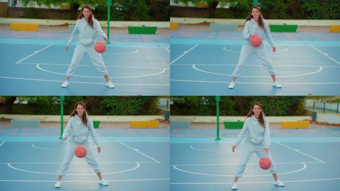 女子篮球运动员在当地球场户外训练和锻炼的特写镜头。年轻女子训练用篮球交叉弹跳。慢动作街头篮球