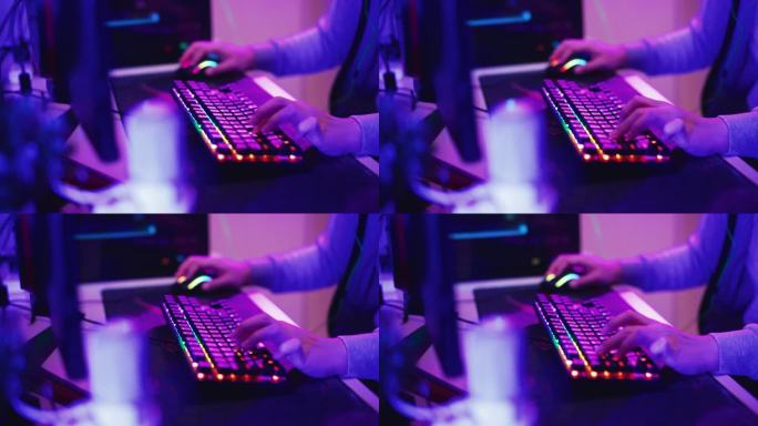 近距离键盘玩家玩电子游戏彩色霓虹灯电脑