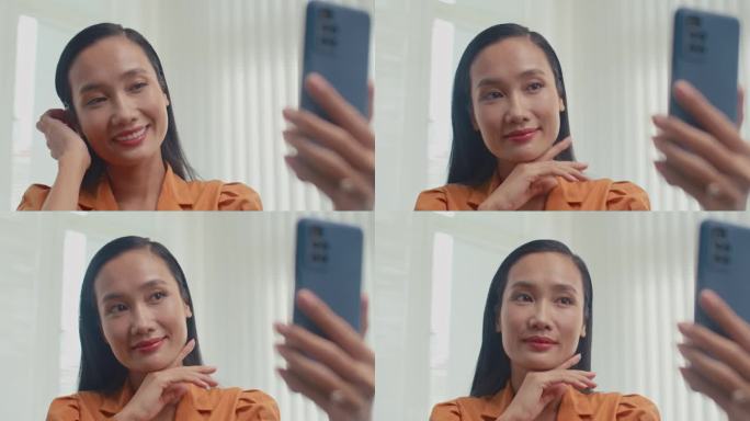 亚洲女性在诊所美容后用手机自拍