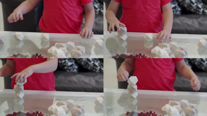 蹒跚学步的小男孩在玩益智玩具土石木石