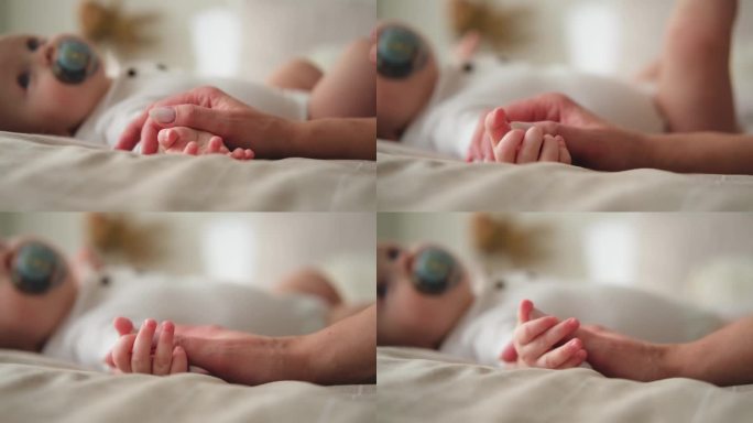 幸福的家庭。刚出生的小婴儿，小婴儿，小手放在妈妈的手心上。新生儿出生后握着父母的手指。妈妈宝宝在家。