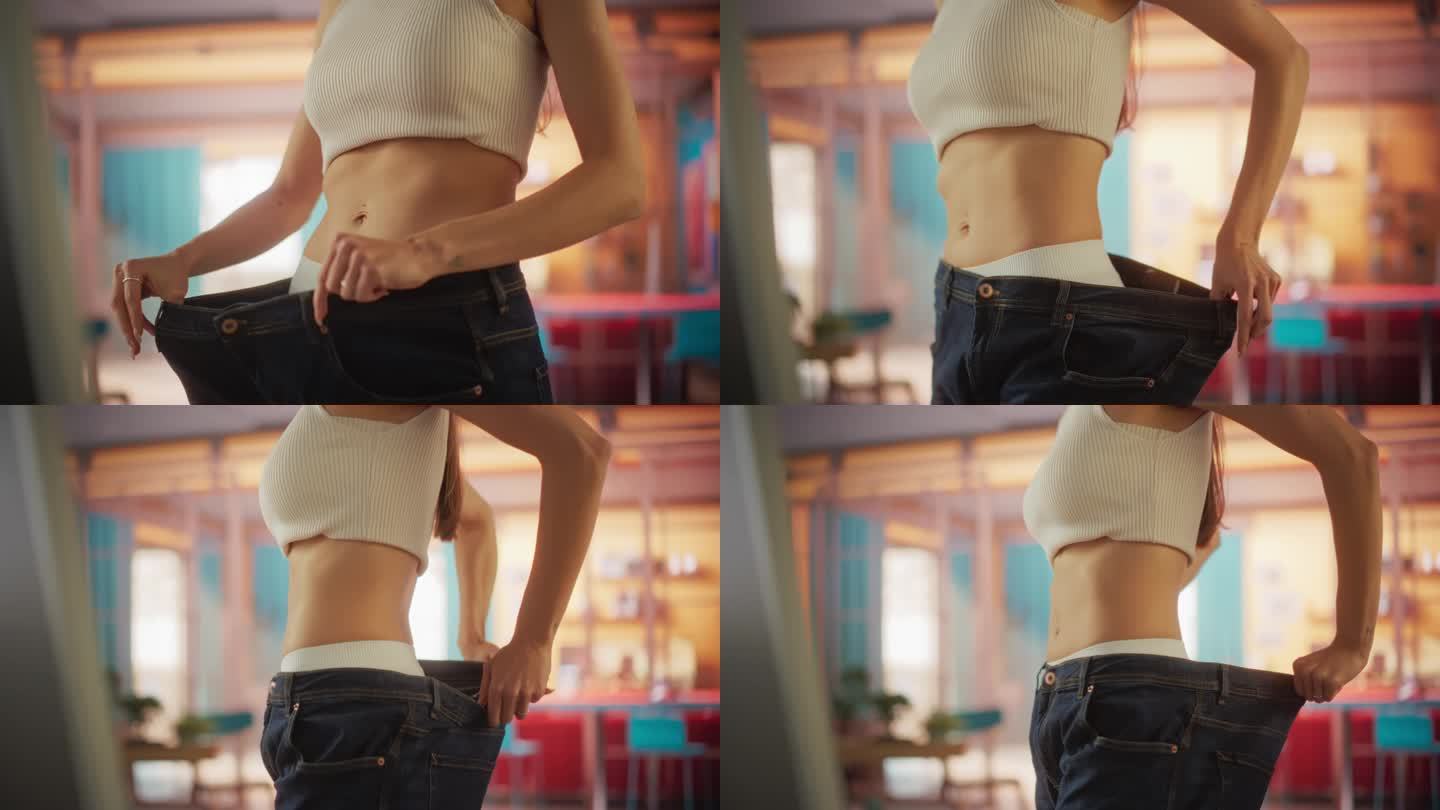 近距离慢镜头拍摄美女在节食前试穿旧牛仔裤的浪费。女性注意到健康生活方式带来的不同。健康饮食和锻炼的结