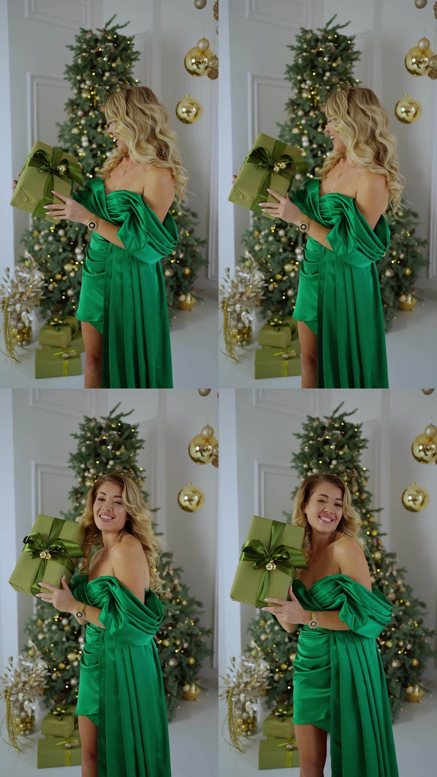在新年庆祝活动中，身穿晚绿礼服的快乐女子在摇礼盒。新年和圣诞节假期的概念