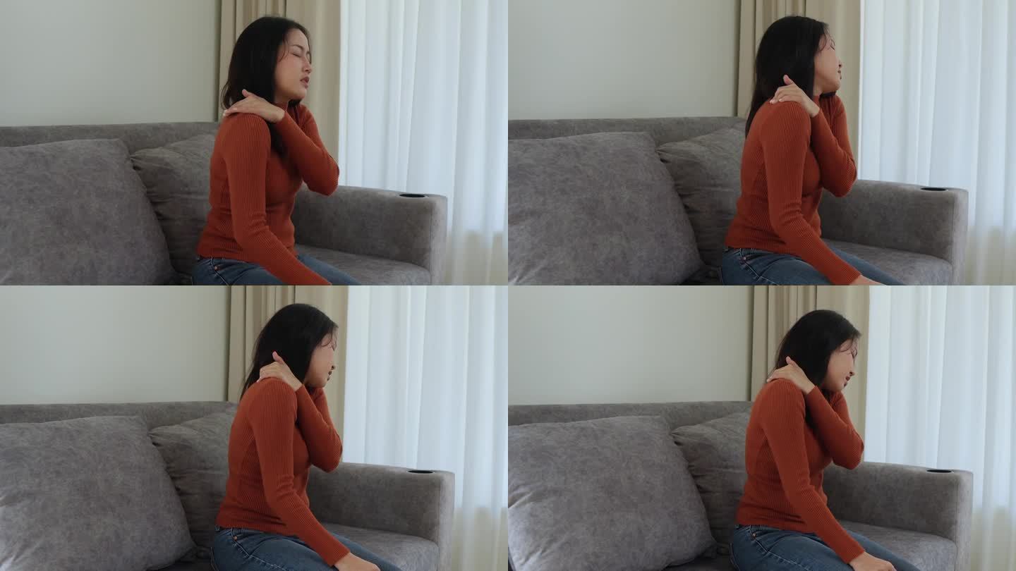 亚洲女少女因工作疼痛伴腰痛，抱着按摩揉肩痛或酸痛，在家坐在沙发上疼痛。医疗保健的人。