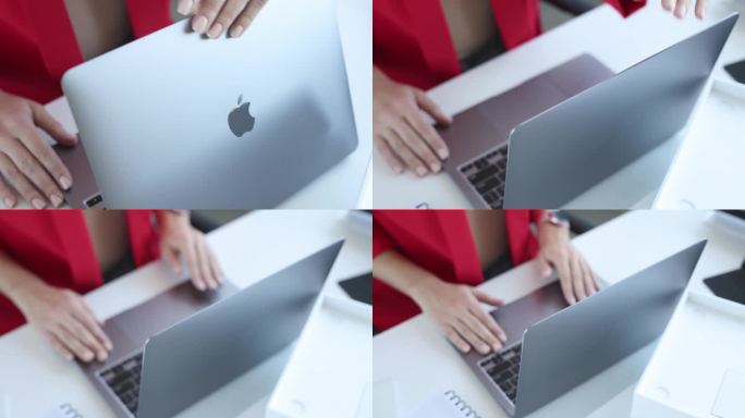 女子打开新款银色笔记本电脑苹果MacBook air的盖子，特写4k电影慢动作