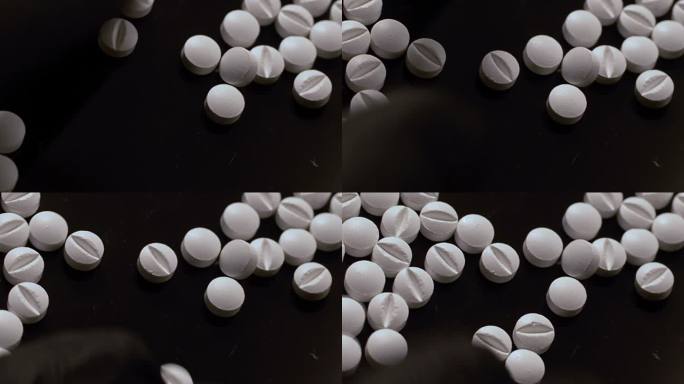 选药时，白色片剂用一只手带着黑色手套分开。俯视图