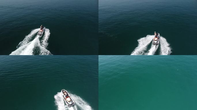 空中俯瞰的水泡沫痕迹与漂亮的深蓝色海洋阴影。在一艘动力强劲的小型摩托艇后面，平静的海面上有一条美丽的