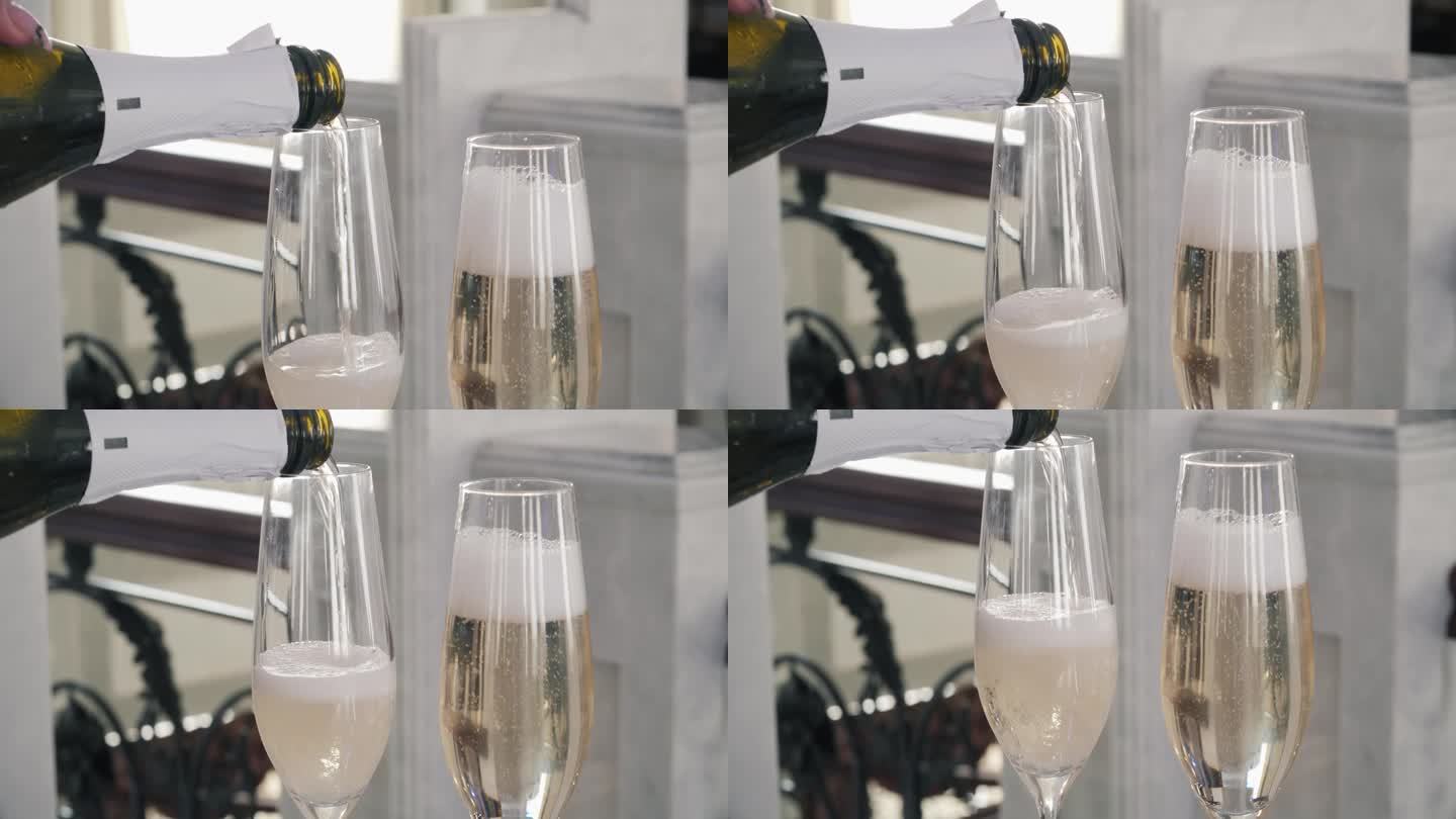 两个杯子的特写，香槟正在倒。为活动而喝。