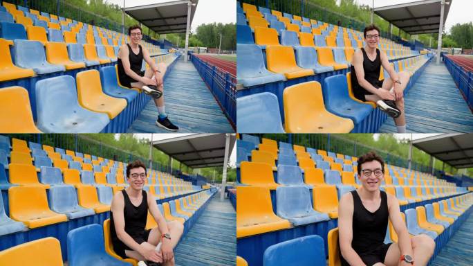 这个人坐在体育领奖台上看着镜头，镜头移动，慢镜头，黄蓝色的看台，广角镜头