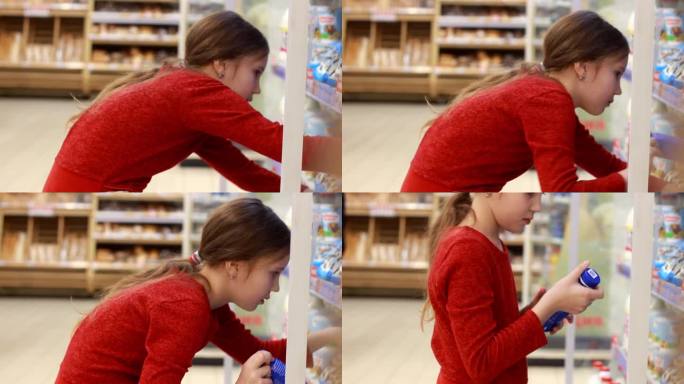 小女孩在商店里选择健康的酸奶。一个女孩正在研究乳制品的成分。乳制品站。特写镜头