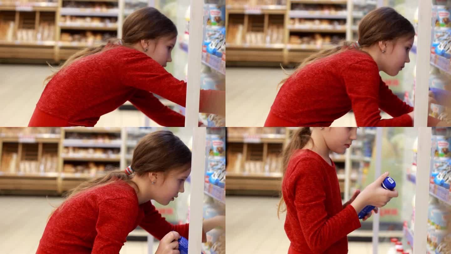 小女孩在商店里选择健康的酸奶。一个女孩正在研究乳制品的成分。乳制品站。特写镜头