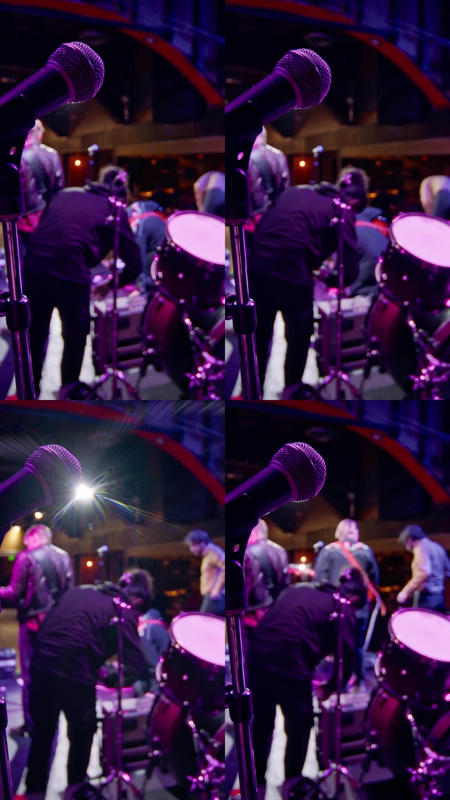 麦克风的垂直镜头与摇滚乐队设置在背景中