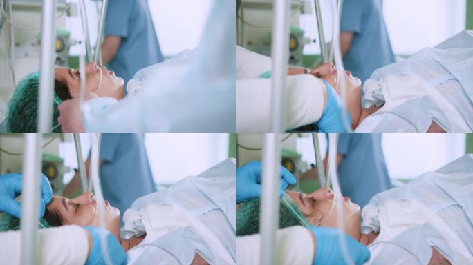 手术中病人的特写。现代手术室里，一名妇女躺在手术台上，全身麻醉，还戴着呼吸管。专业的外科医生使用腹腔