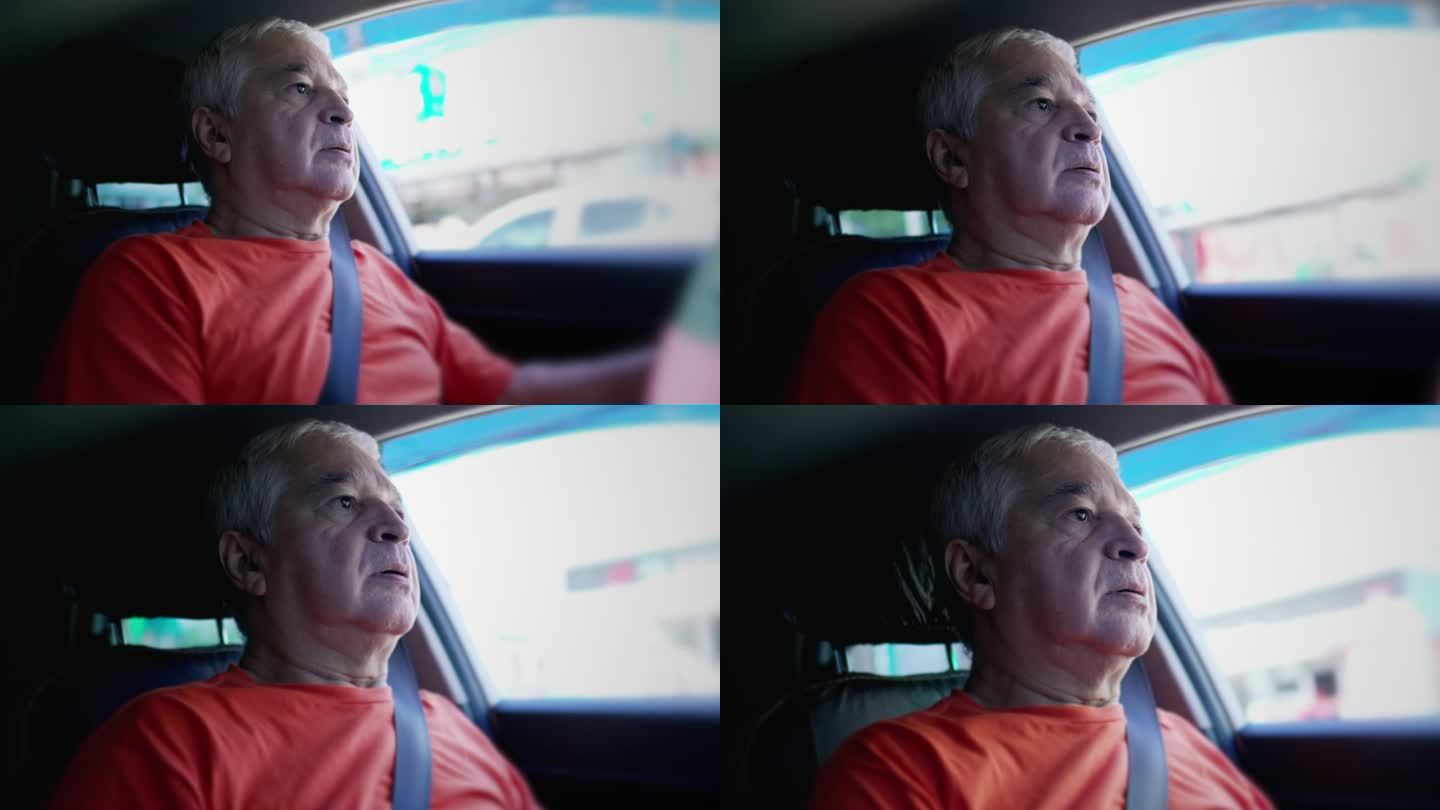 沉思的老人开着车，表情若有所思，车内