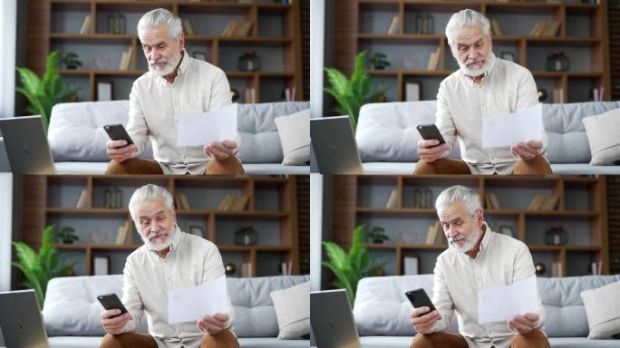 快乐的老人坐在家里的房间里用智能手机使用手机应用程序支付账单