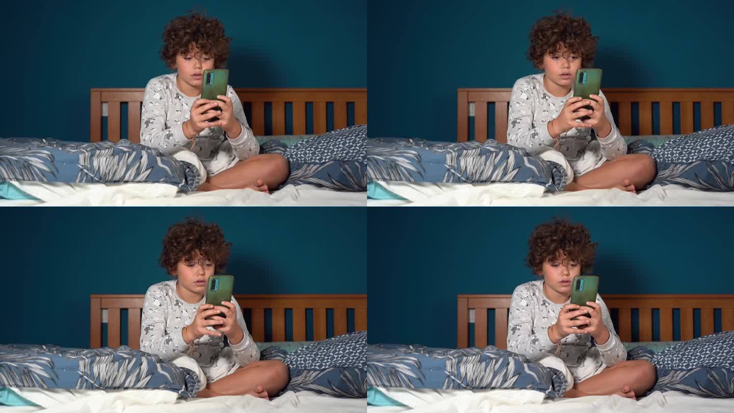 9岁男孩带着智能手机上床睡觉——童年时期的疲劳和对社交媒体和互联网的沉迷——睡前看互联网是一个坏习惯