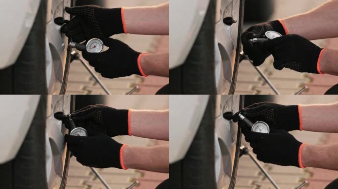 在特写镜头中，机械师使用压力表检查轮胎压力