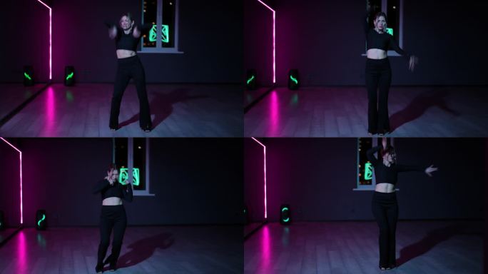 住相机。在霓虹灯照亮的黑暗舞蹈大厅里跳舞的女人。富有表现力、活跃的Waacking舞蹈。
