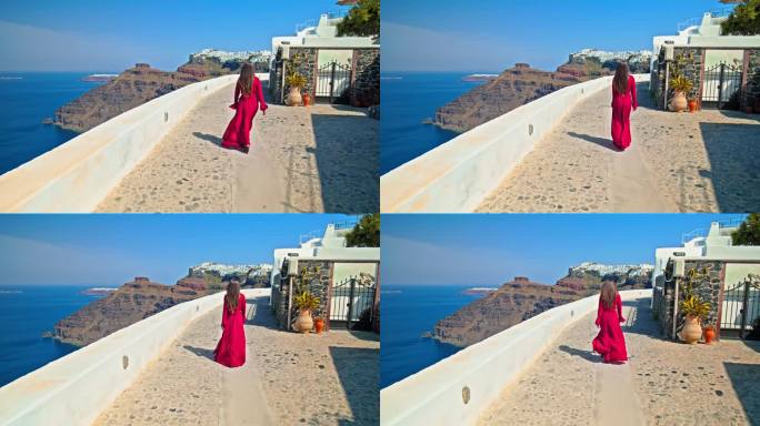 一个穿着红裙子的美丽女孩走在圣托里尼，参观欧洲著名的旅游景点。
