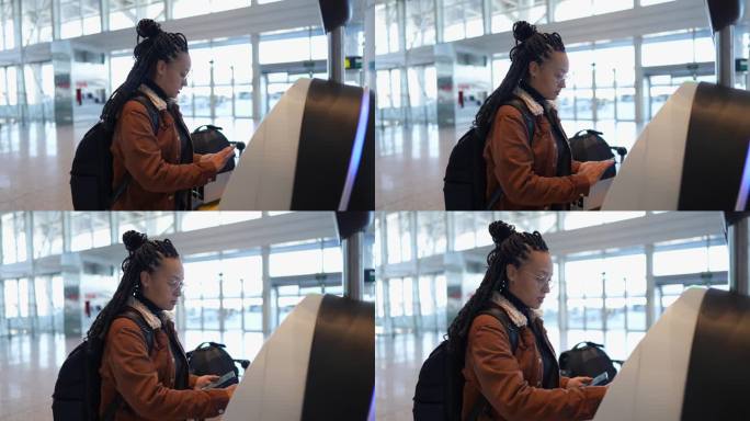 年轻女子在机场使用手机和值机机
