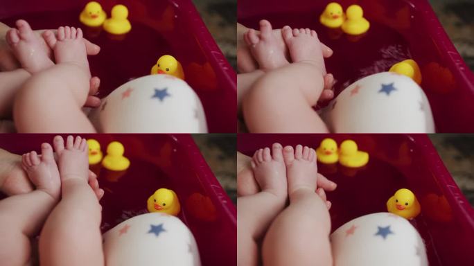 新生儿的脚在母亲的手中，特写。妈妈给宝宝洗脚