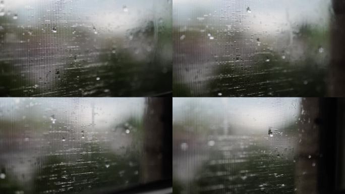 迷人的雨滴在下雨天优雅地从窗户倾泻而下，捕捉到宁静舒缓的氛围。