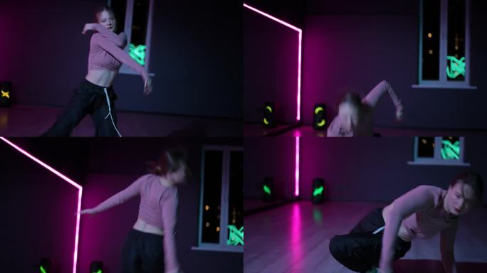 住相机。一个女孩在舞蹈大厅里用霓虹灯照亮的镜子跳当代舞。