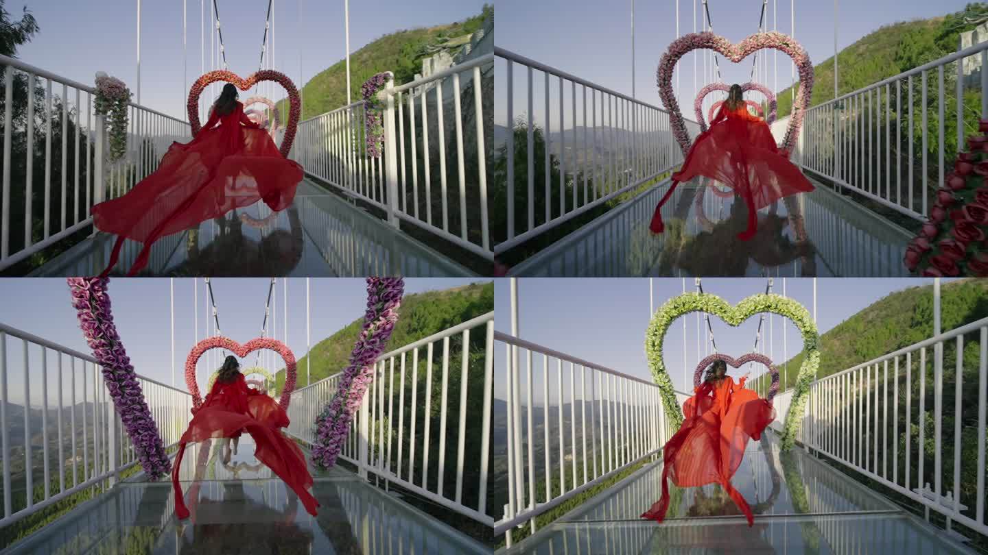 红裙子女子在有心形装饰的玻璃吊桥上奔跑
