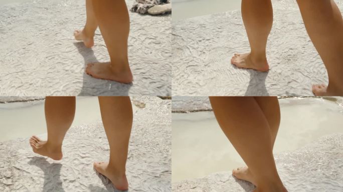 女性的腿在古老的白色方解石沉积物上行走，并踏入Pamukkale石灰华中的矿泉水。
