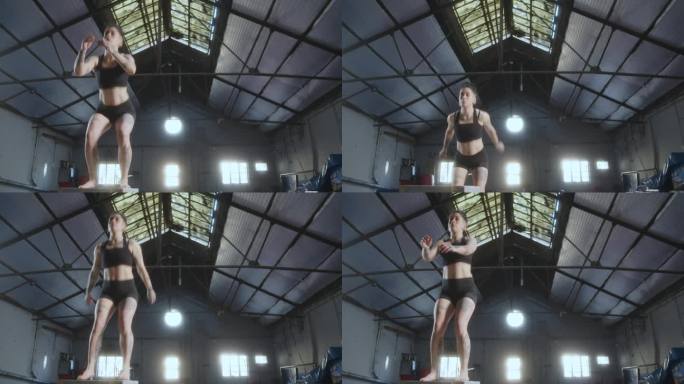 体操女运动员在体操房里练习深蹲跳远