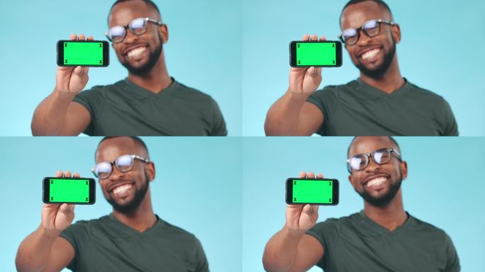 手机，绿色屏幕和跟踪标记屏幕上有一个黑人在蓝色背景的演播室。主页，网站和chromakey在移动显示