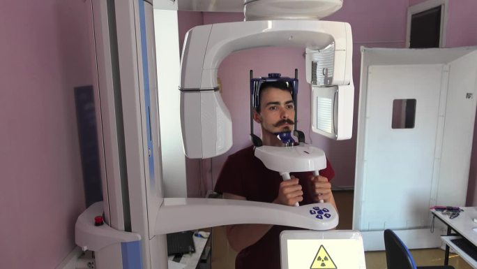 在牙科实验室里，一名男子正在做头部和口腔的x射线扫描