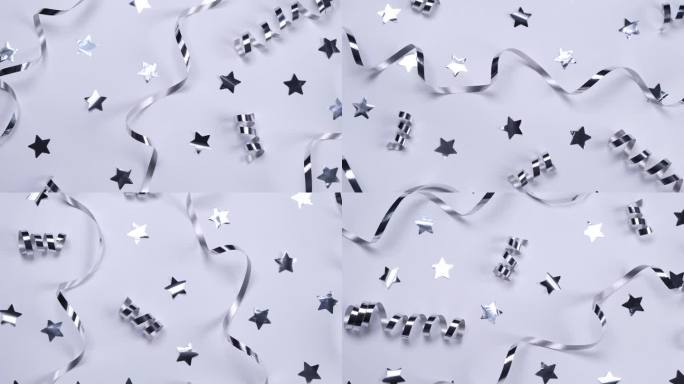 背景以银色蛇形图案和白色背景上的星星为背景，以银色色调庆祝生日、聚会或周年纪念的概念