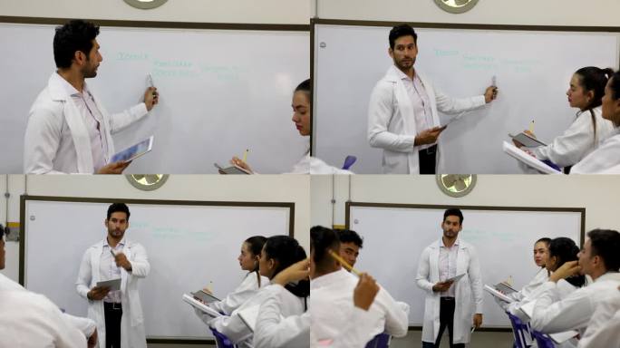 男老师在白板上向生物系学生解释一个概念，所有学生都在密切关注并提出问题