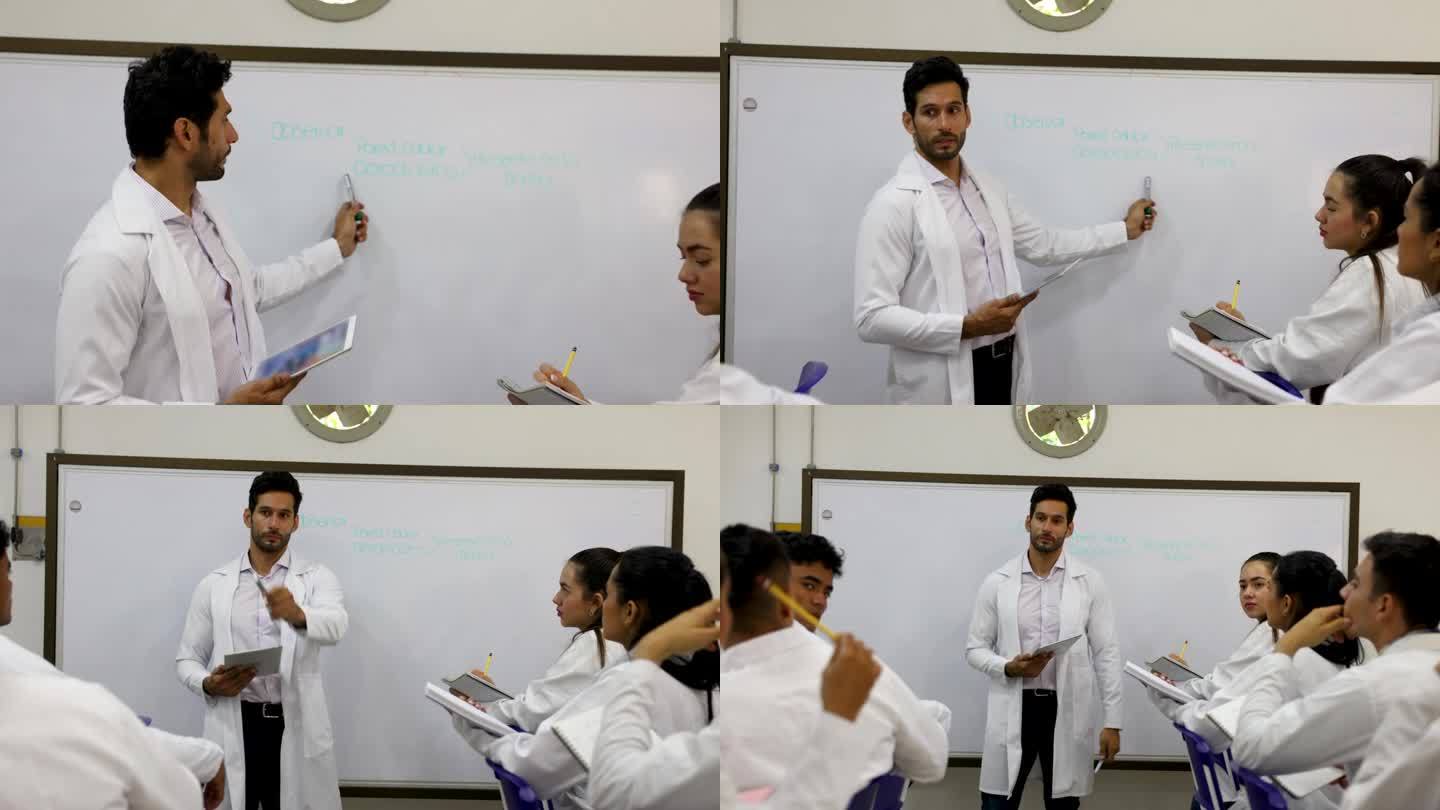 男老师在白板上向生物系学生解释一个概念，所有学生都在密切关注并提出问题