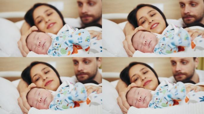 幸福的多民族家庭，母亲和父亲带着刚出生的男婴在产后医院。初为父母的脸上洋溢着喜悦和幸福的情绪。