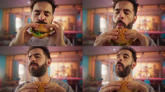 跟踪一个正在家里享受美味汉堡的男人的慢动作肖像。一个快乐的男人点了快餐，五彩缤纷的环境，高品质的认可