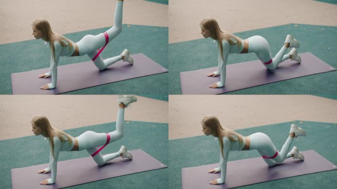 运动女孩用阻力带做臀肌反冲练习